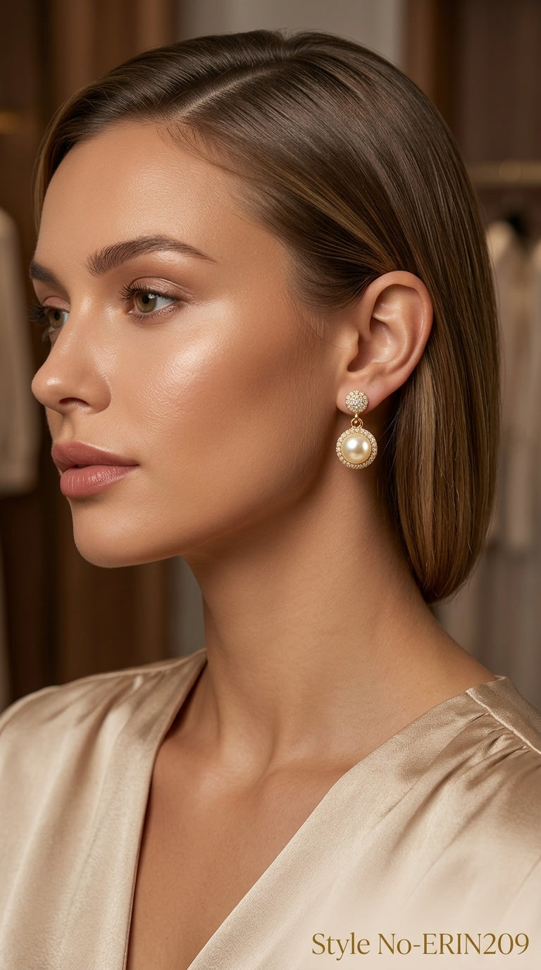 Gold tone faux pearl drop earrings with paved stone halo